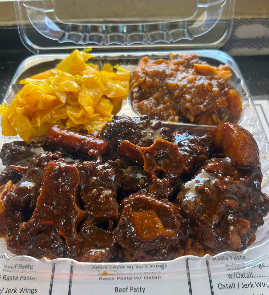 Oxtail dinner in brown gravy over rice with steamed cabbage