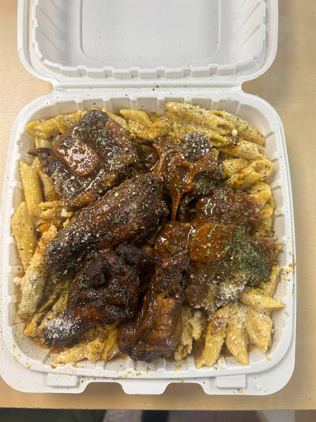 Rasta pasta loaded with oxtail and jerk wings